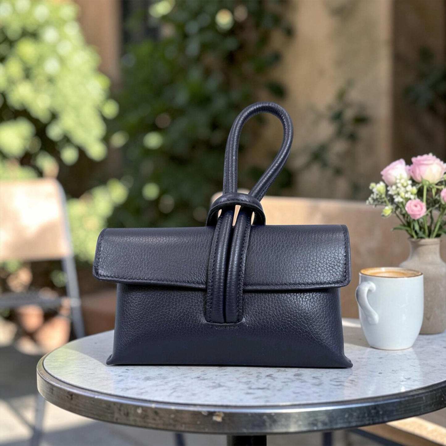 Grain Rectangular Wrist Clutch With Sculptural Knotted Loop Handle And Full Overlay Flap Closure